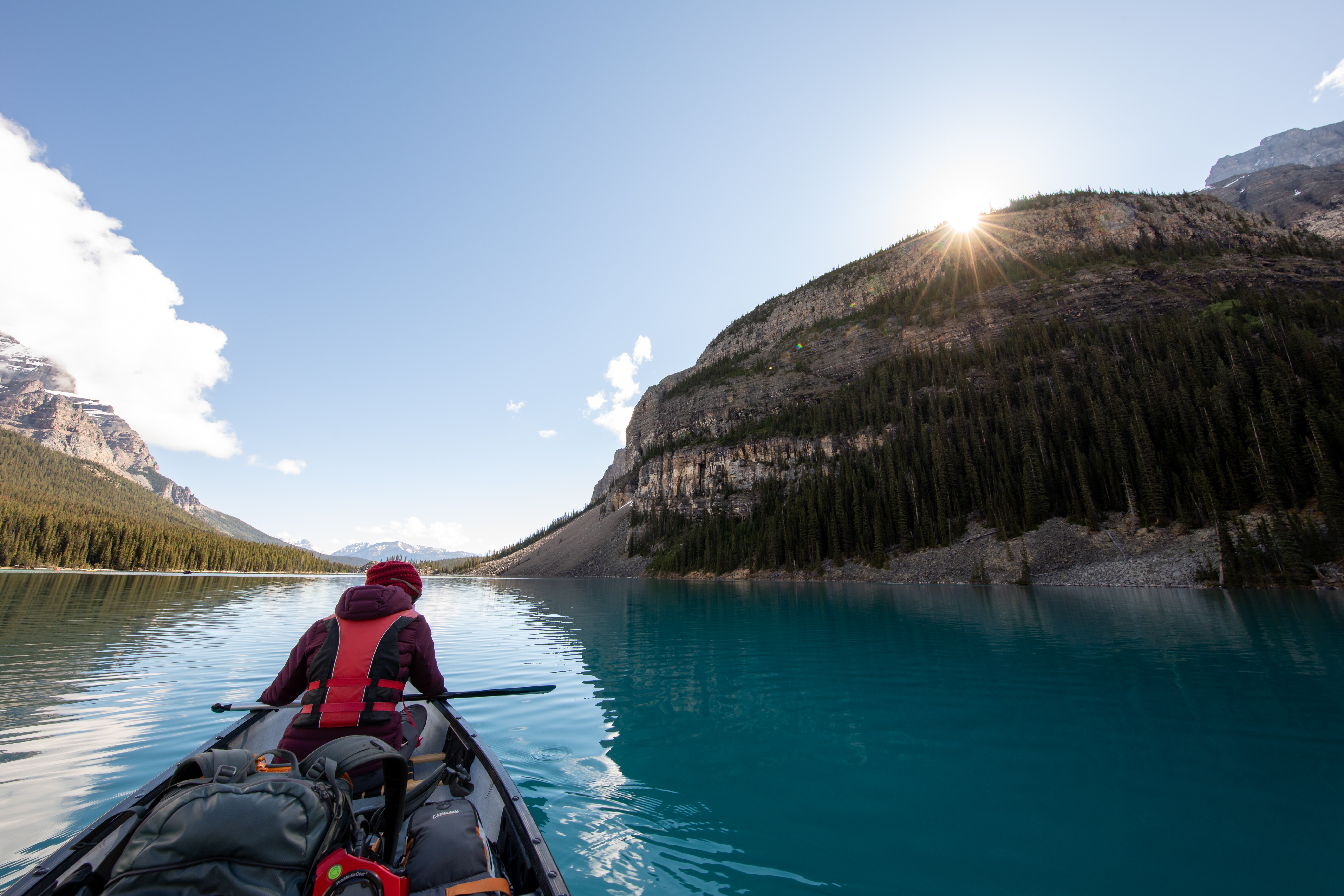 person kayaking down a gentle river
