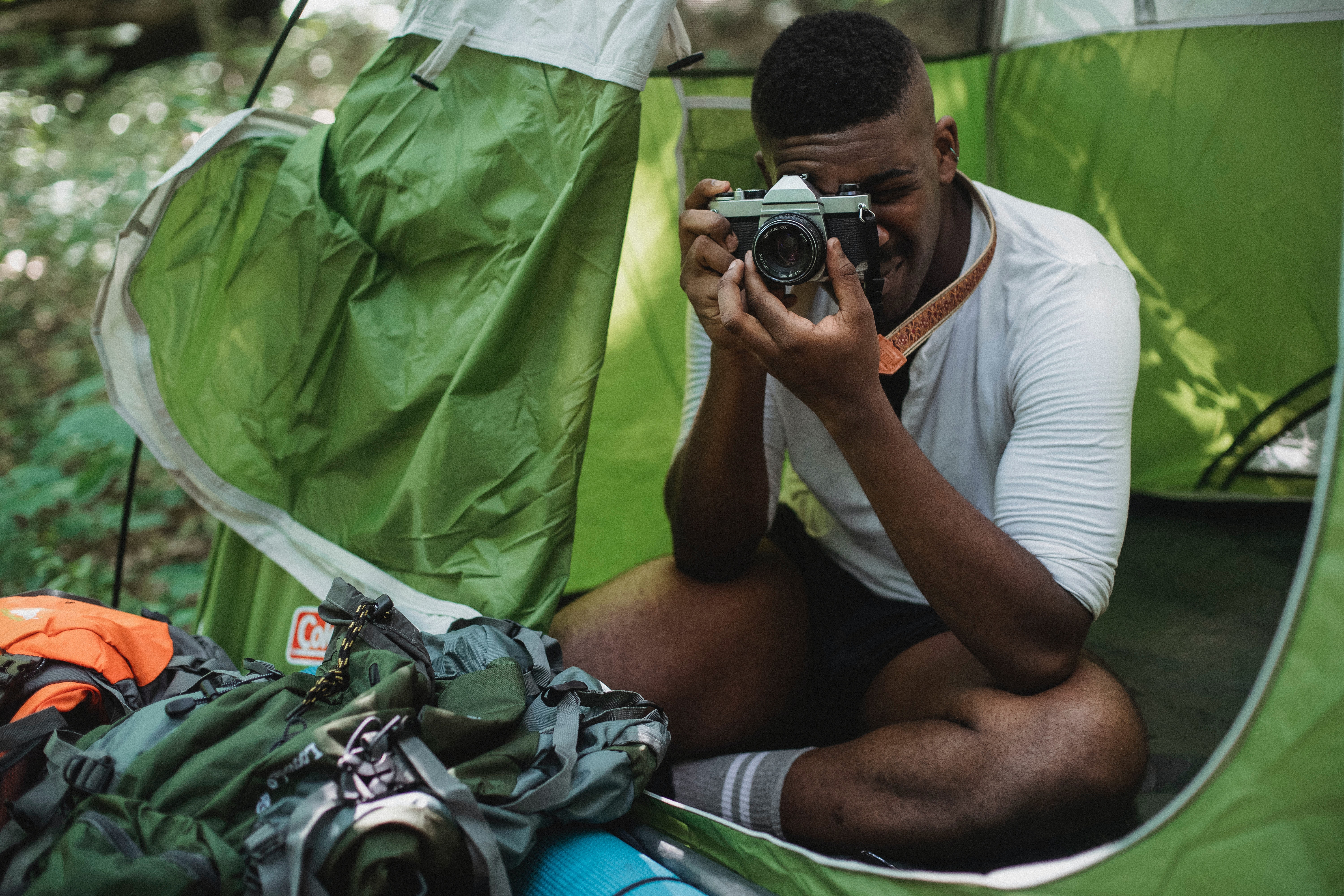 person taking a photo from a tent outside